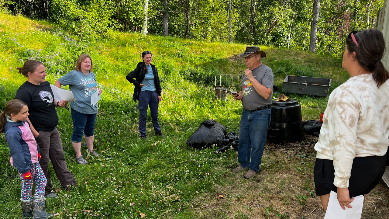 Six community members gathered and listening to instructions