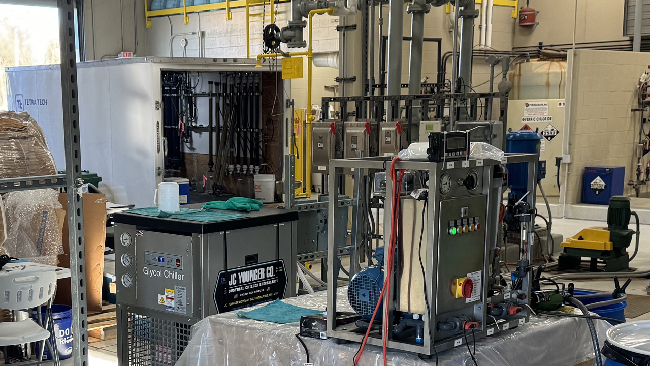 Indoor industrial equipment setup with a glycol chiller and various machinery in a workshop environment