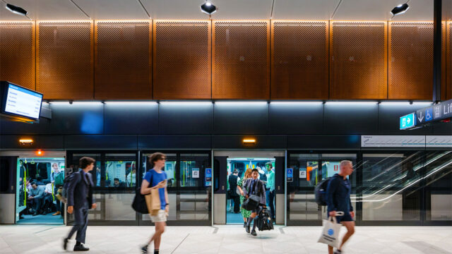 Passengers exiting a train on a metro platform