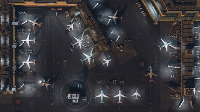 Arial view of passenger jets parked at gates at an airport terminal
