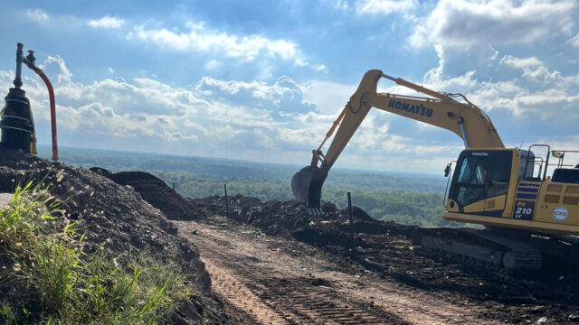 Tetra Tech field team conducting landfill gas well installation with safety barricades and monitoring equipment in place