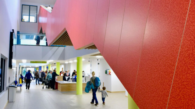 People walking through the reception area of a Leisure Centre
