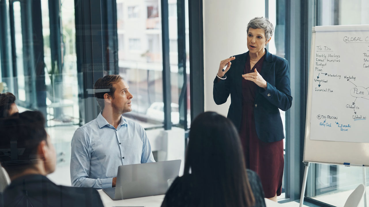 Group of people training in a boardroom 