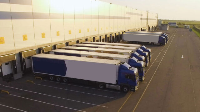 Lorries lined up at a warehouse loading bay