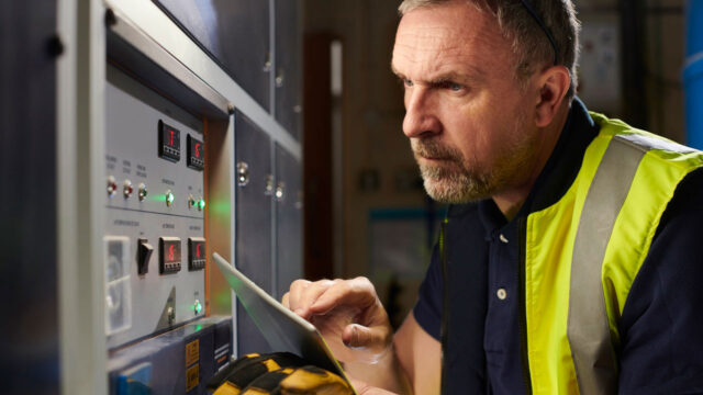 Engineer checking electrical systems display 