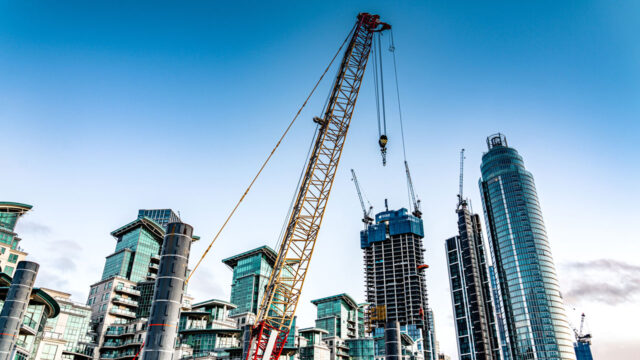 City skyline with high rise buildings and construction crane