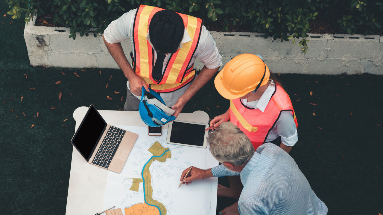 A group of engineers looking at a site plan