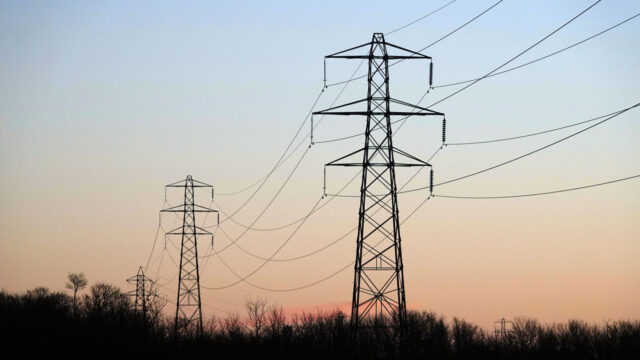 Electricity transmission towers in an Essex nature reserve at sunrise