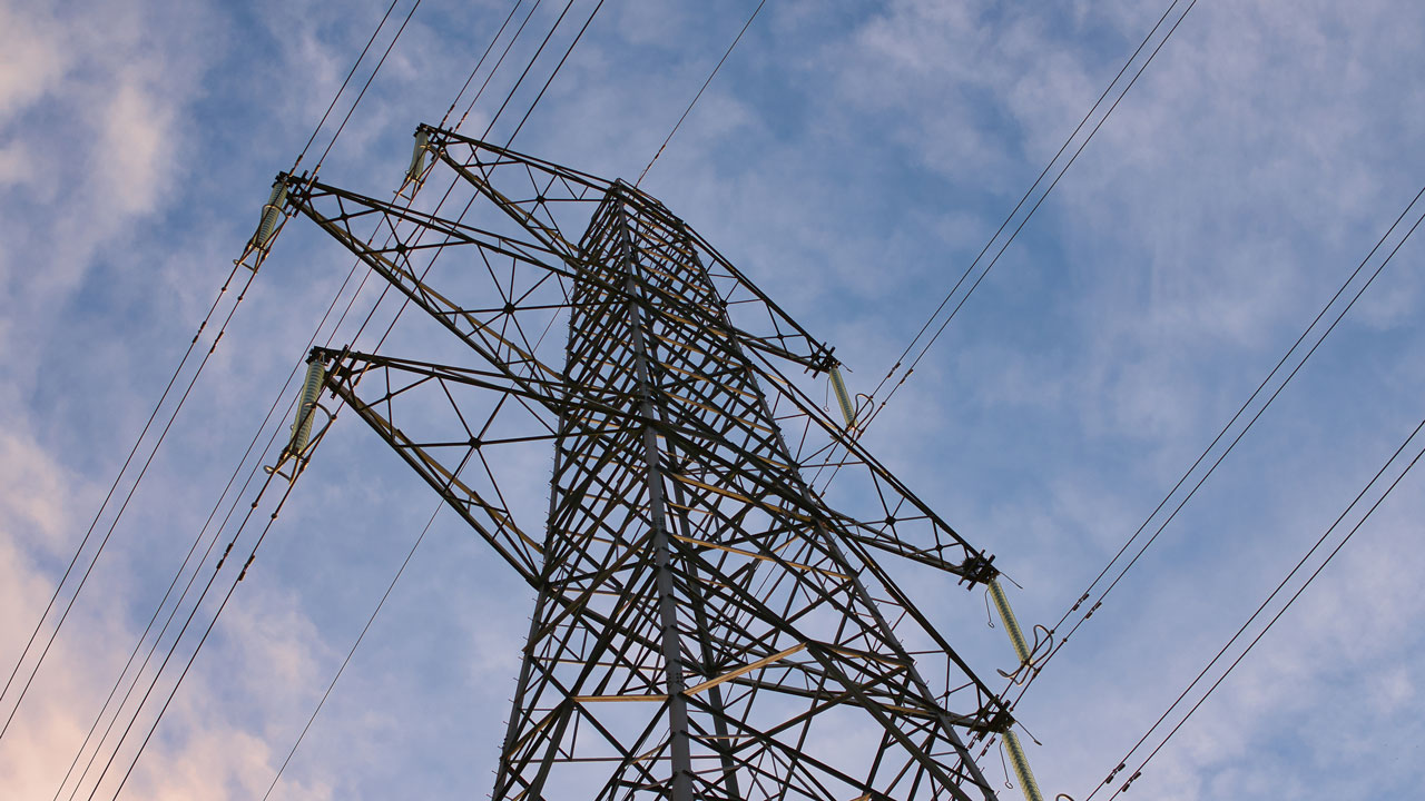 View looking upwards at high voltage electricity pylon 