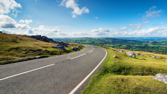 A main road with roadworks cutting through the beautiful Welsh countryside