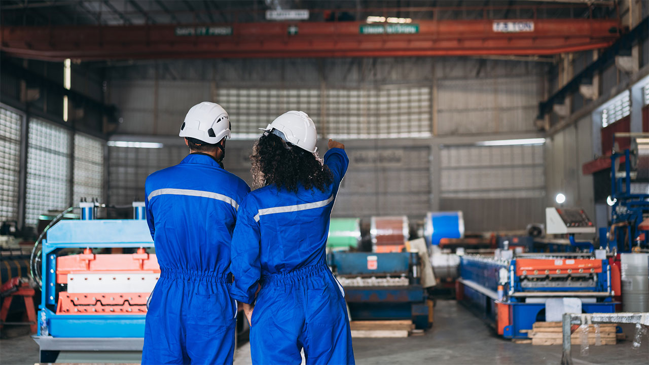 Two people in a warehouse using 