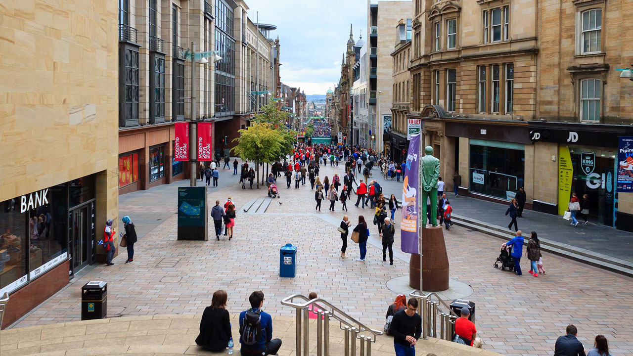 People in a pedestrianised city centre retail street