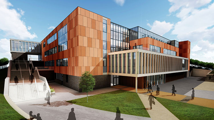 A modern building with a mix of orange and glass facades, featuring multiple levels and large windows with pathways and green grass in the foreground