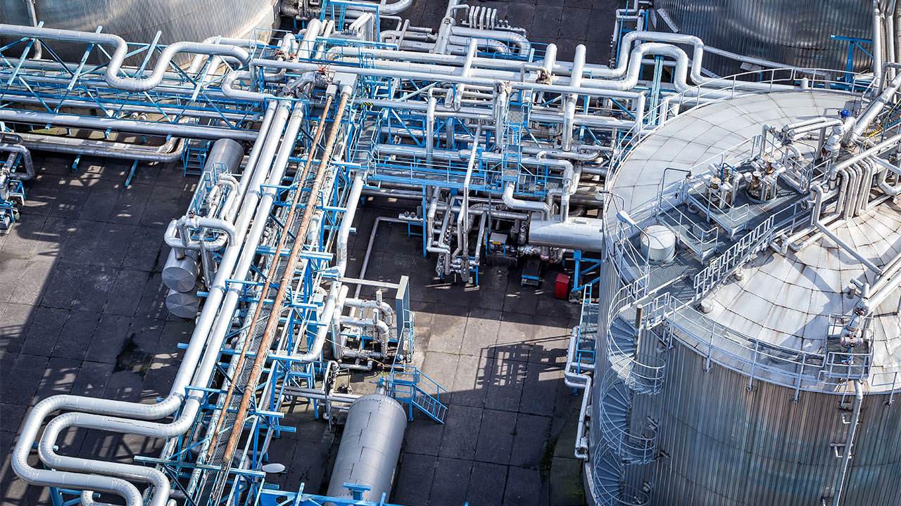 View of the pipes and connected infrastructure of geothermal processing and energy storage tanks