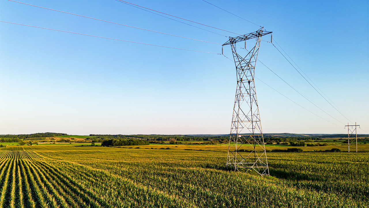 A high voltage power line in a sunny fiel