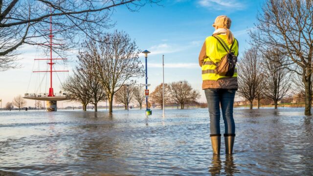 Employee standing in flood water