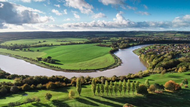 Aerial view of a bend in a river in a rural landscape