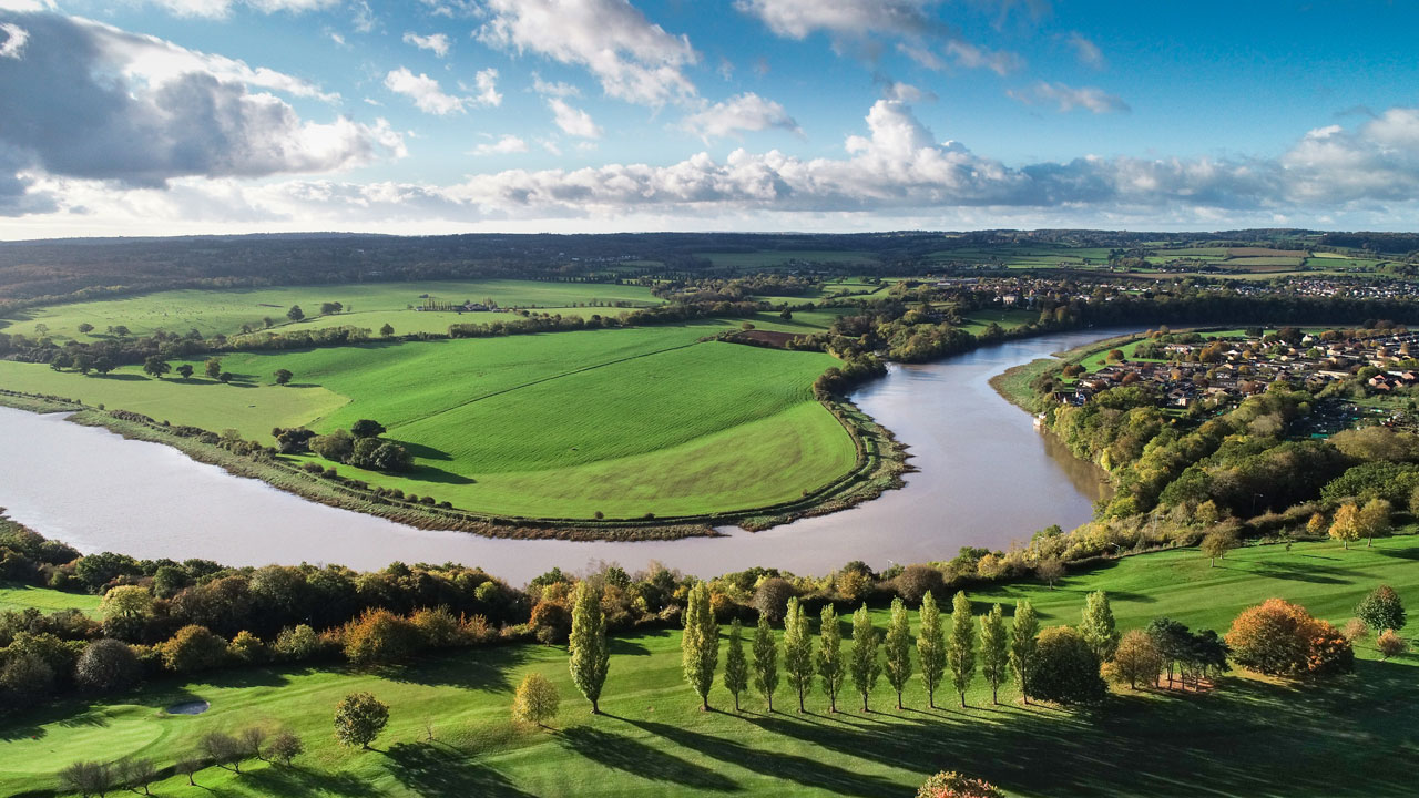 Aerial view of a bend in a river in a rural landscape