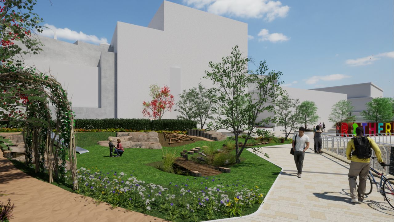 A digital rendering of an urban park with green grass, trees, flowers, a wooden play structure, and people walking and interacting. A colourful “Rotherham” sign is visible in the background near white modern buildings under a blue sky