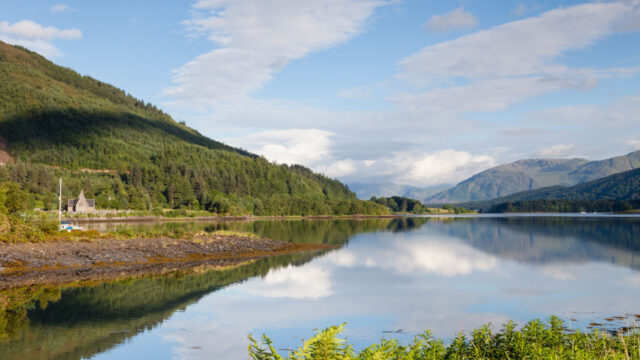 A view of a river with mountains behind
