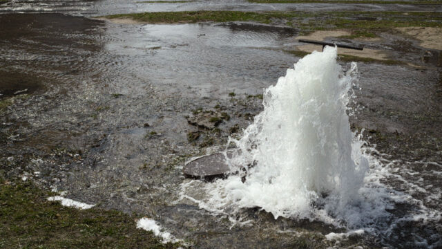 Sewer overflow flooding an area of grassland