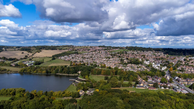 Aerial drone photo of water reservoir and town alongside