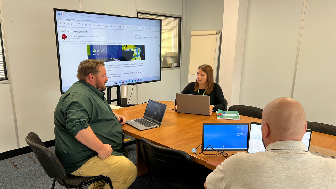 People in discussion around a table in a meeting room