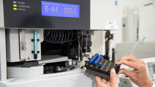 Technician using laboratory sampling equipment