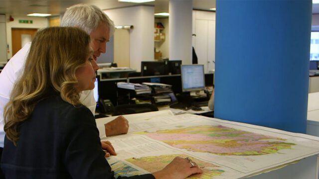 Members of our specialist energy technical and advisory team reviewing maps at a desk for a project