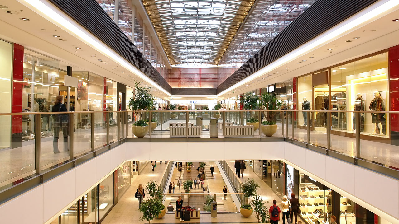 A large light-filled atrium inside a shopping centre