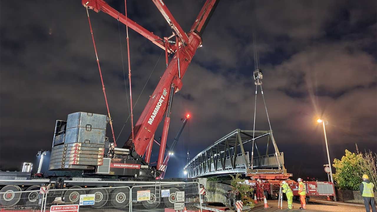 Nighttime view of a crane on a bridge construction site