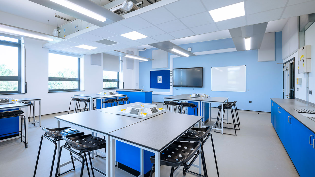 Render image of a classroom with tables and chairs