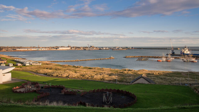 View of Peterhead Harbour with a blue sky in the background over a calm sea