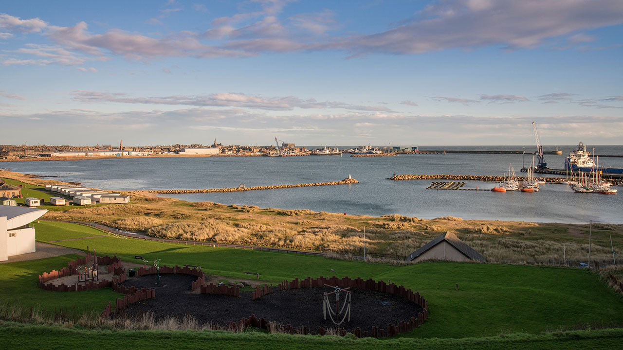 View of Peterhead Harbour with a blue sky in the background over a calm sea