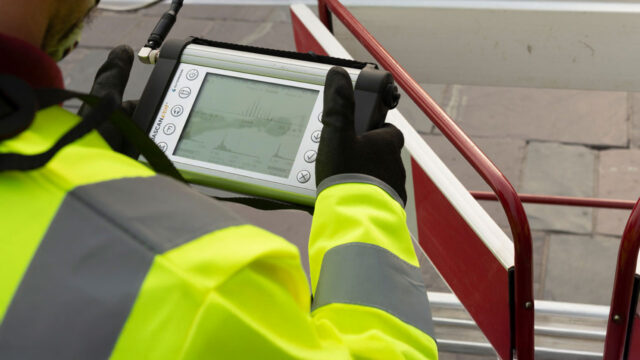 Water technician views image on detection device