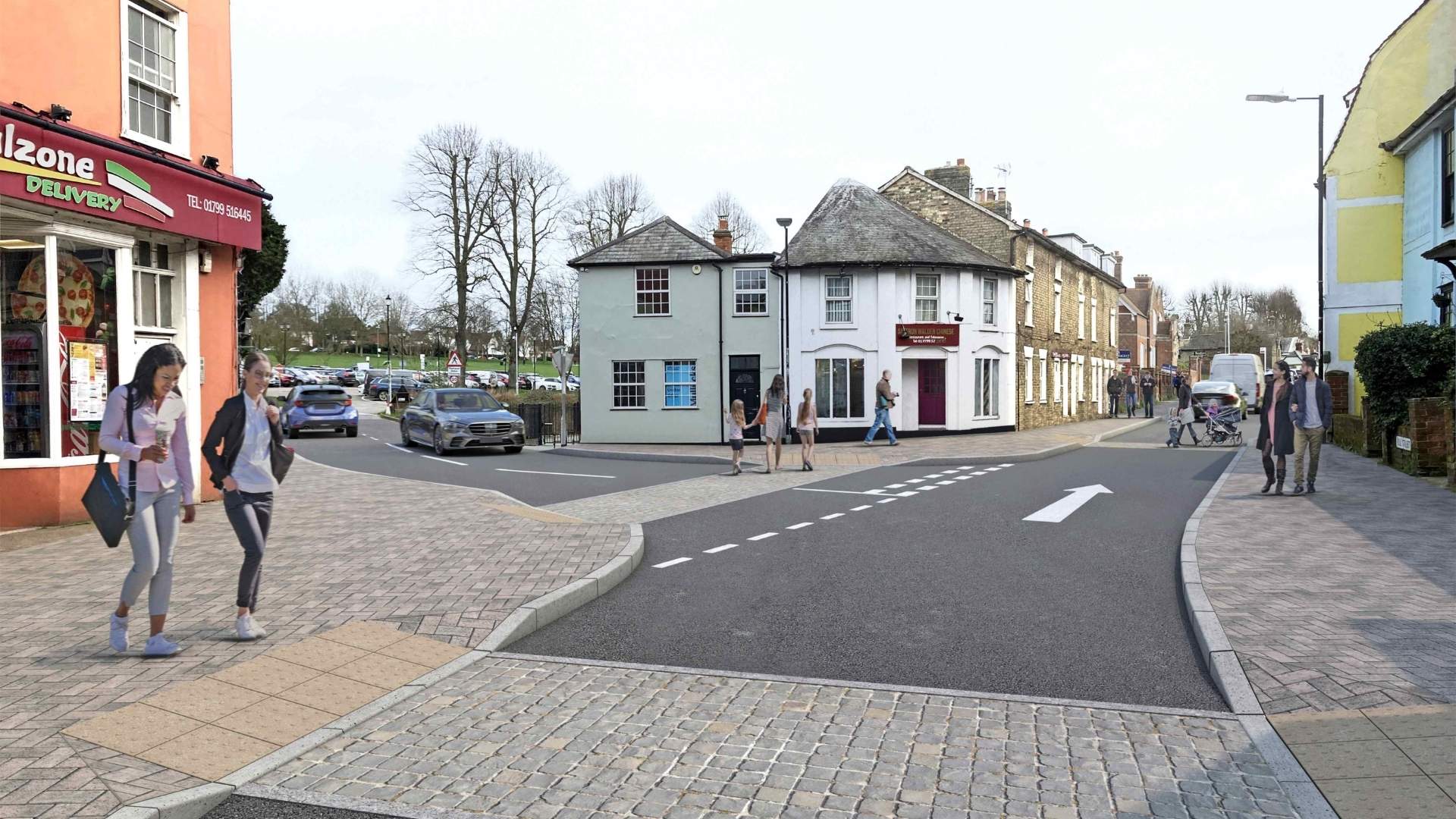 A street scene depicting a busy town intersection with pedestrians walking along the sidewalks