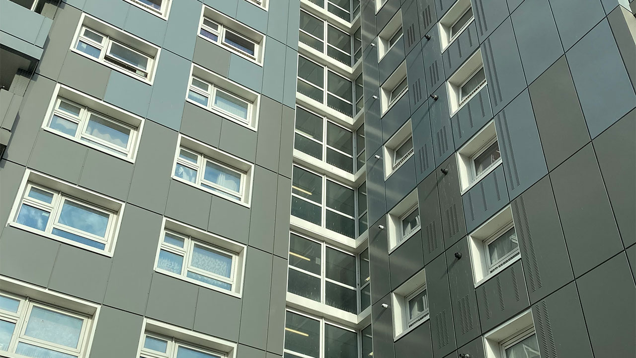 Close up photograph looking up at a block of flats