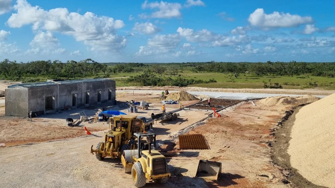 A construction site with heavy machinery and a partially built structure