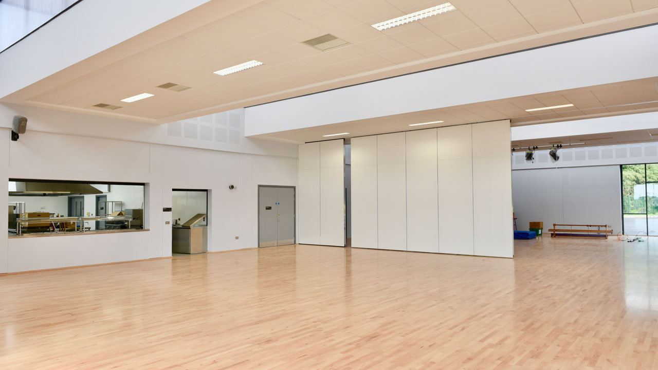 Interior of an empty, sleek school cafeteria that does not yet have tables