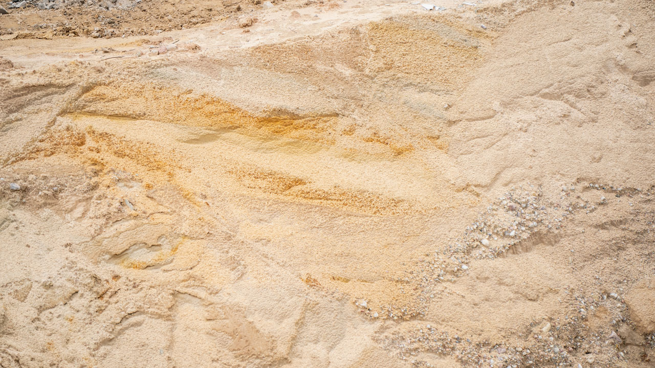 Aerial view of a development site with rough sand and rocks