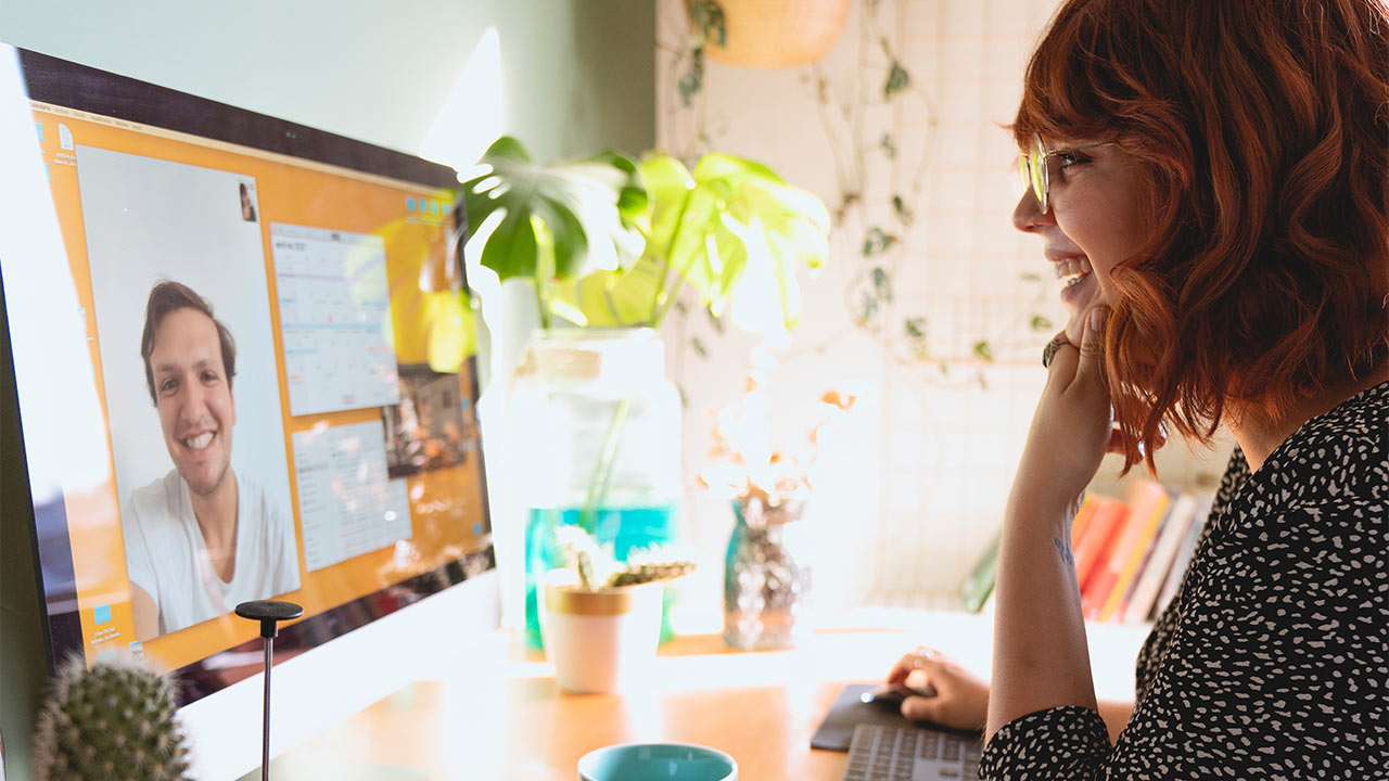 A person speaking to a colleague on a video call
