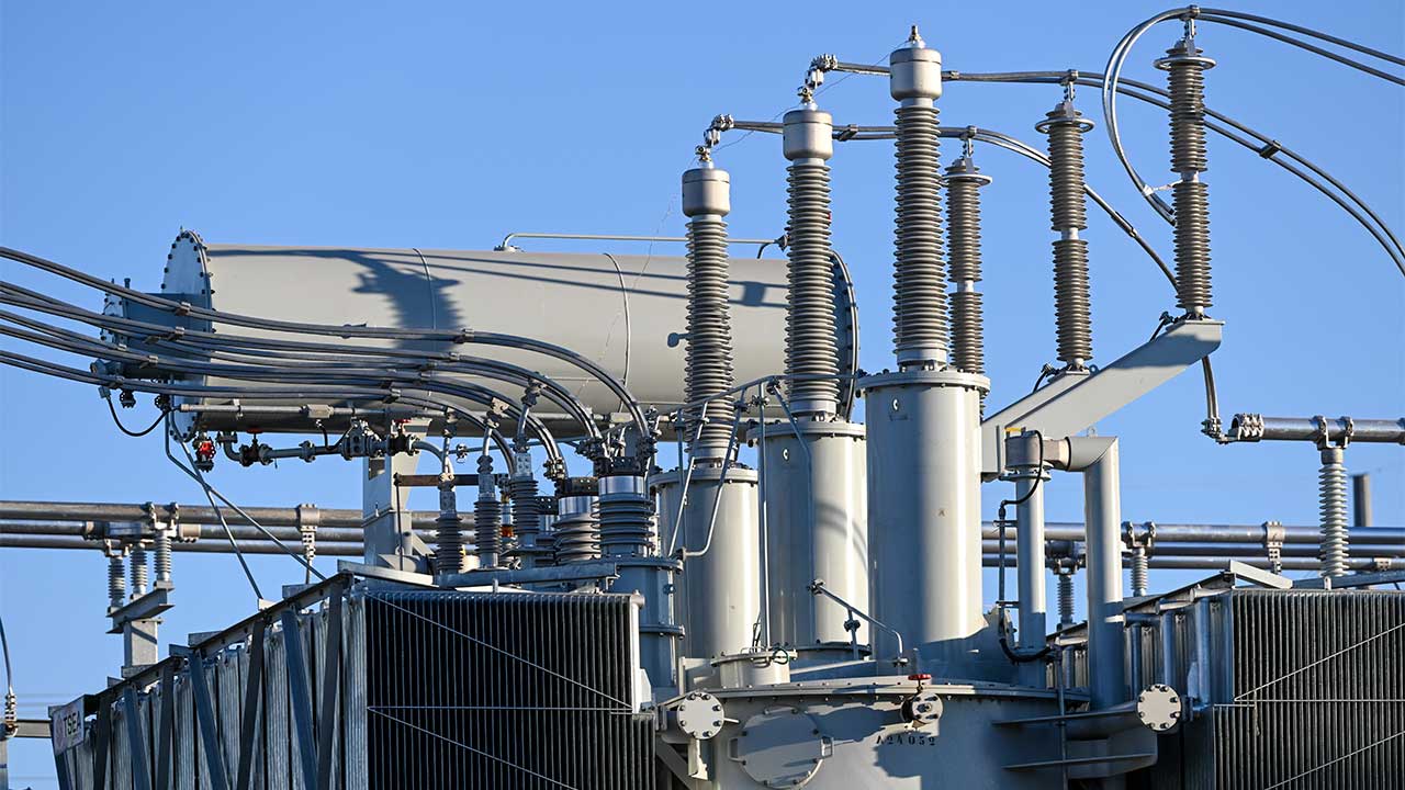 Side view of battery storage facility against a blue sky