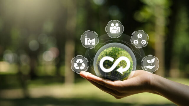 Concept art showing a hand holding icons that represent business and sustainability