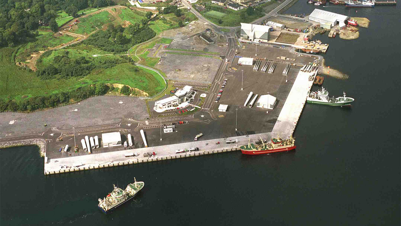 Aerial photograph of a harbour with fishing boats moored and on water