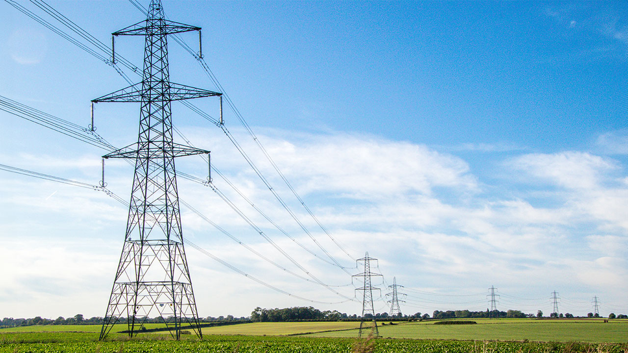 A photograph of electrical towers across open fields