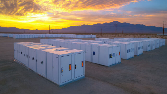 Large-scale battery energy storage facility at sunset in a desert landscape