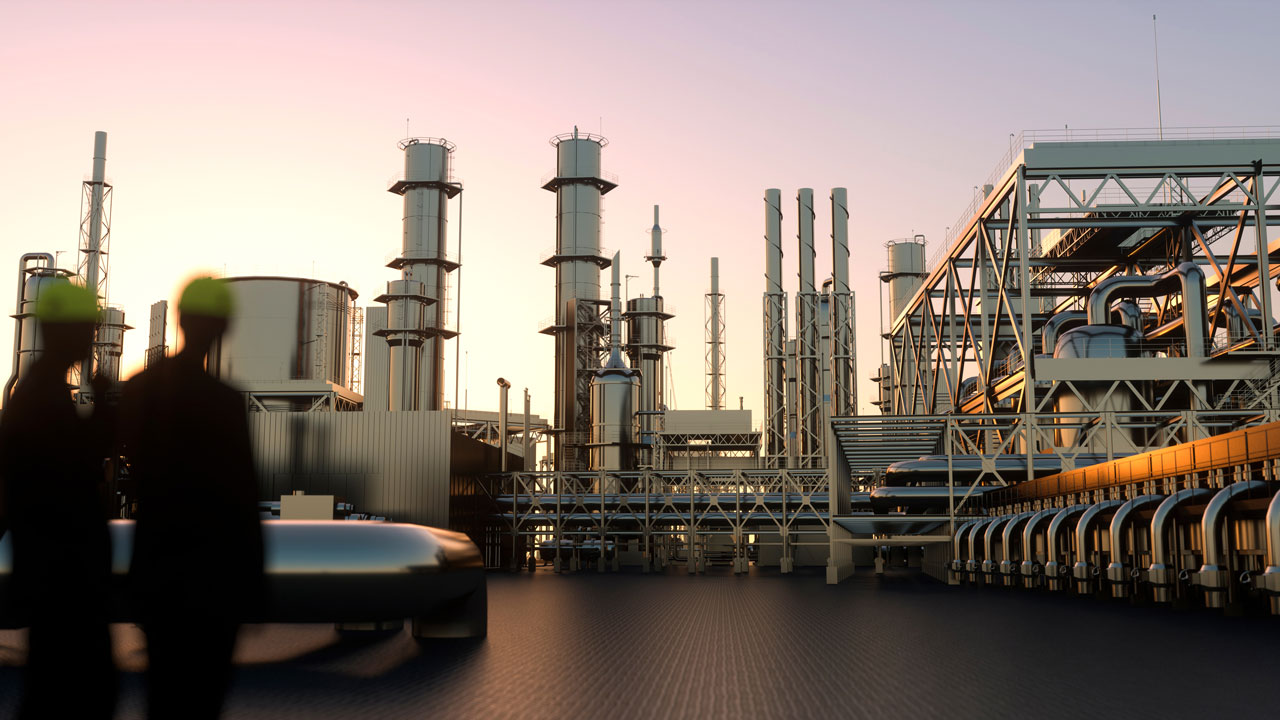 Silhouetted workers in hard hats overlook a large industrial refinery with towers, pipes, and storage tanks