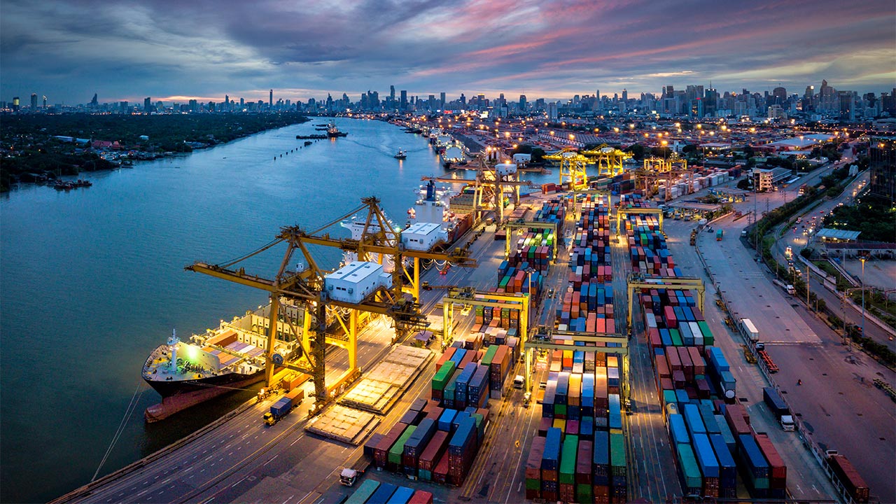 Aerial view of shipping containers along a harbor at night