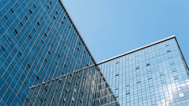 Upward angle of office buildings with blue sky backdrop