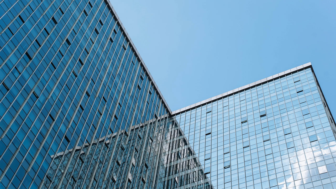 Upward angle of office buildings with blue sky backdrop